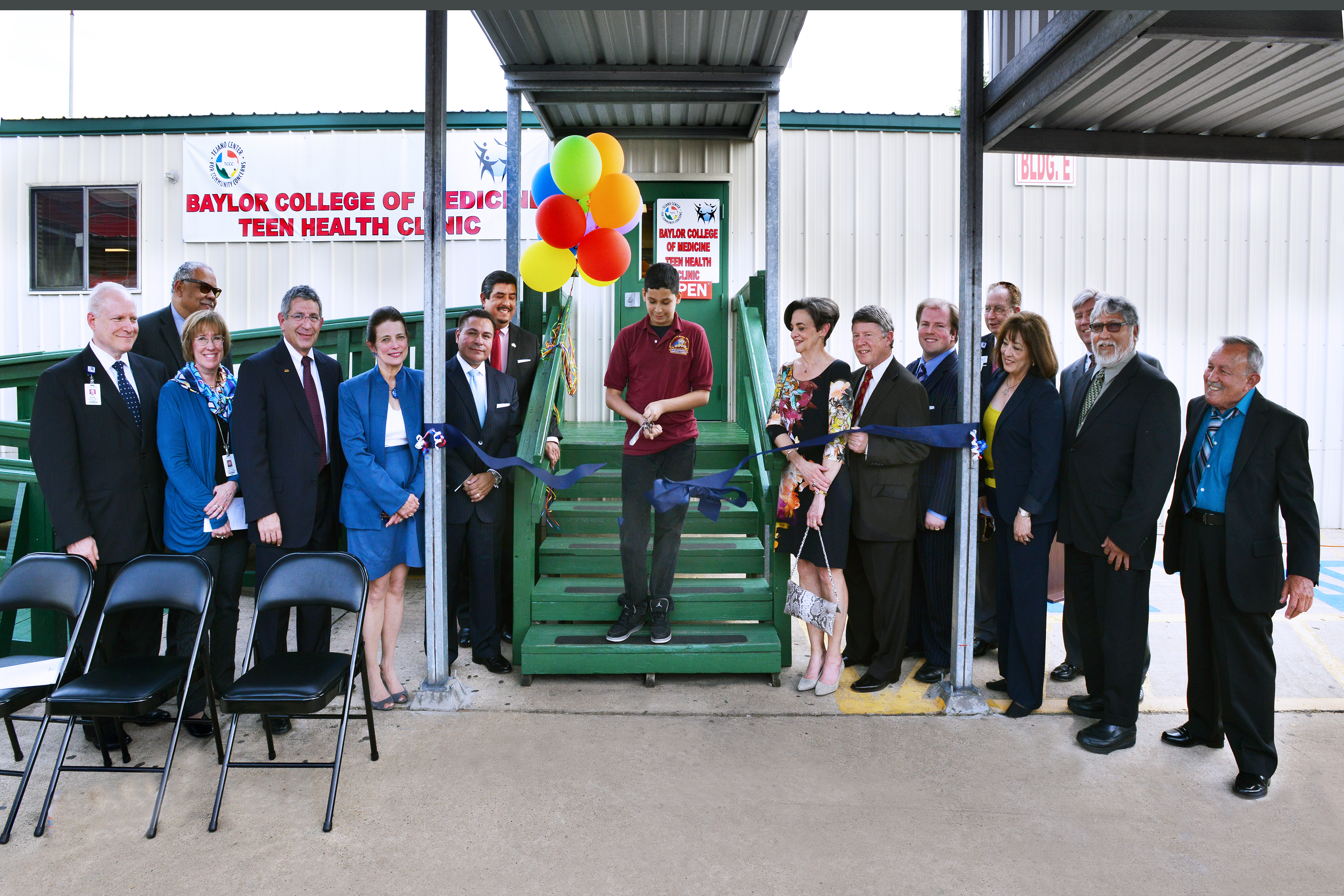 A student at the Raul Yzaguirre School for Success at the Tejano Center for Community Concerns cuts the ribbon on Baylor College of Medicine's newest teen health clinic.