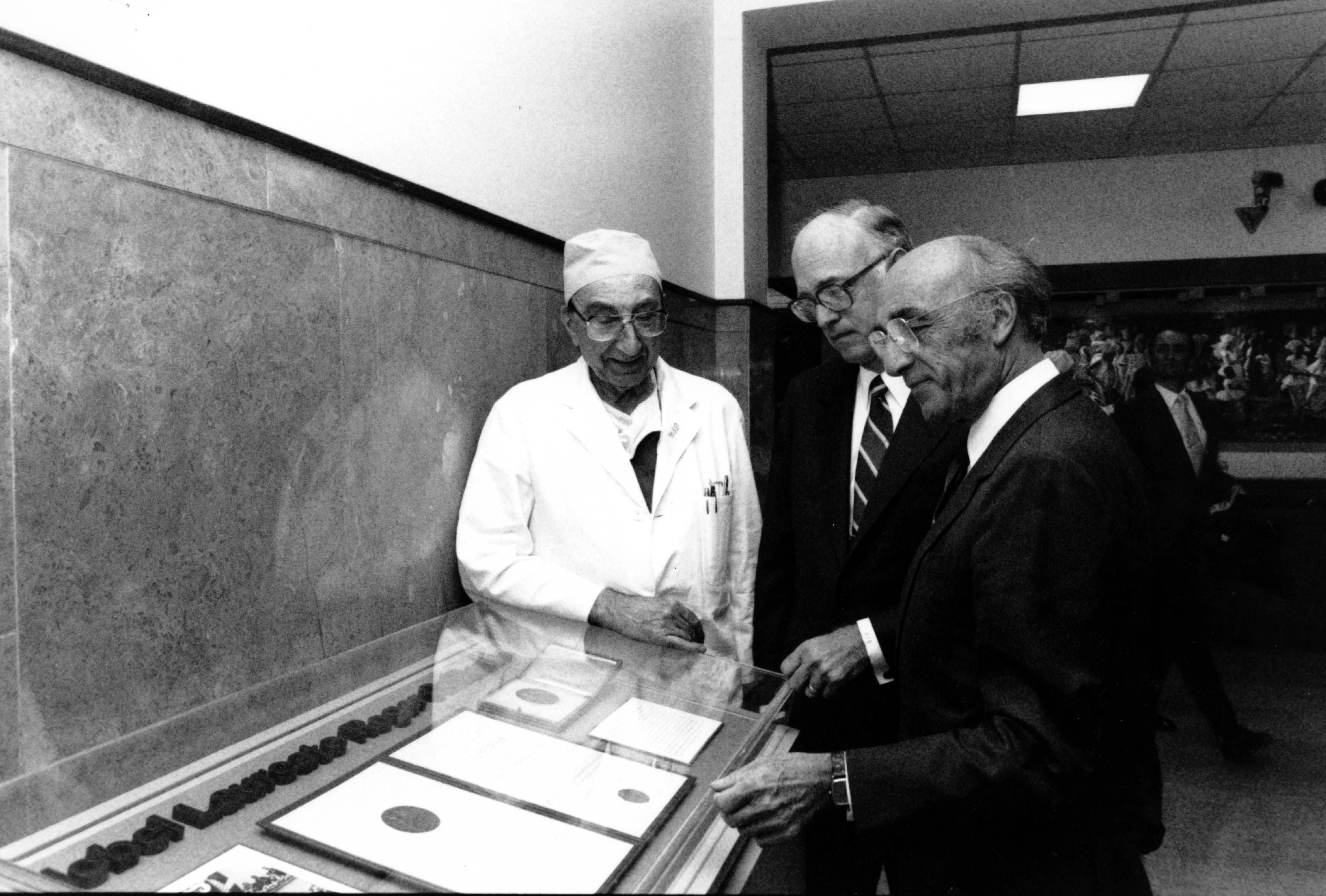 Dr. Michael E. DeBakey, Dr. William T. Butler and Dr. Roger C. Guillemin examin Guillemin's Nobel Prize medal. Photo courtesy Baylor College of Medicine Archives.