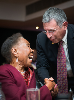 Dr. Paul Klotman, right, congratulates Dr. G.K.T. Chiepe, chair of the Botswana-Baylor Children's Centre of Excellence Community Advisory Board, in Gaborone, Botswana. (Photo by Smiley N. Pool)