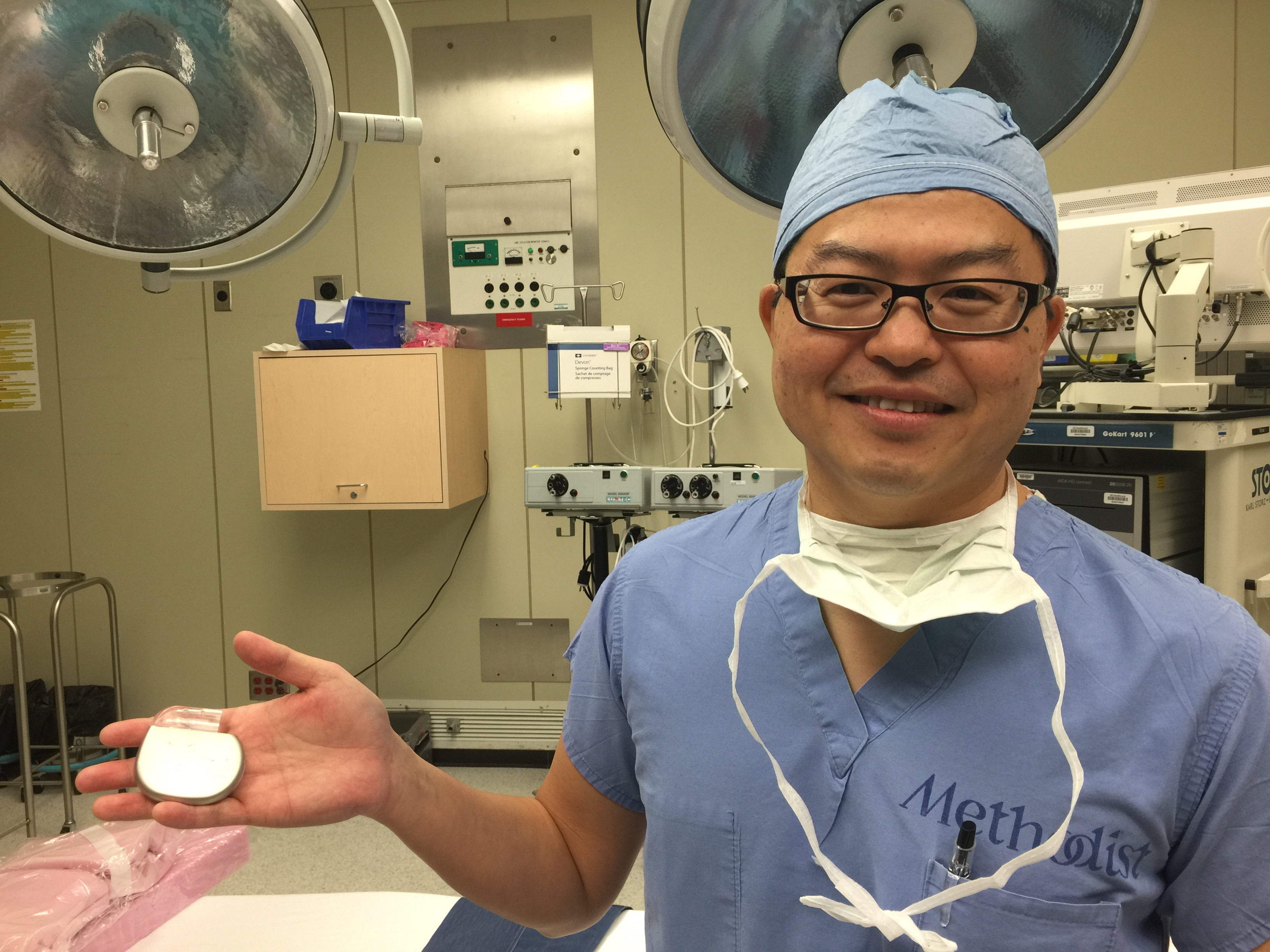 Dr. Mas Takashima holds  the hypoglossal nerve stimulator.