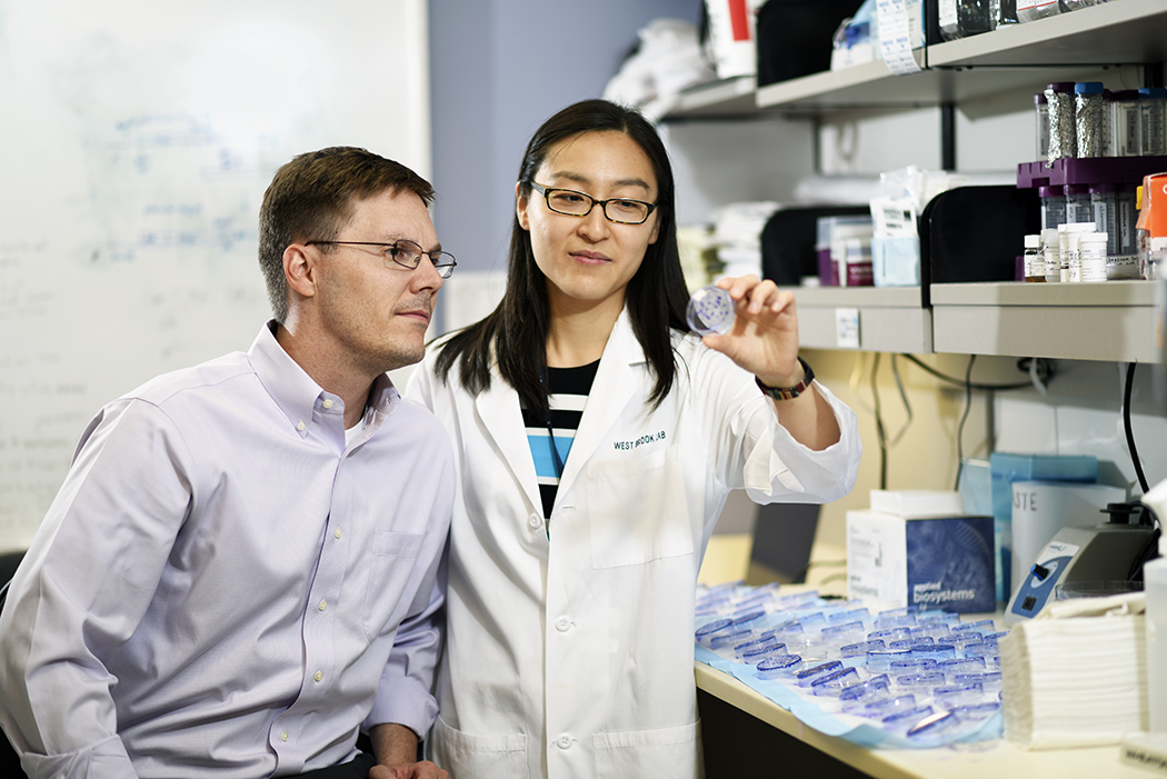 Dr. Westbrook and Tiffany scrutinize a piece of data.