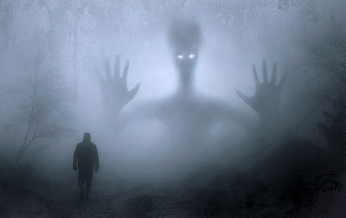 A graphic illustration showing a person walking through a foggy forest with a large, ghost-like entity in their path.