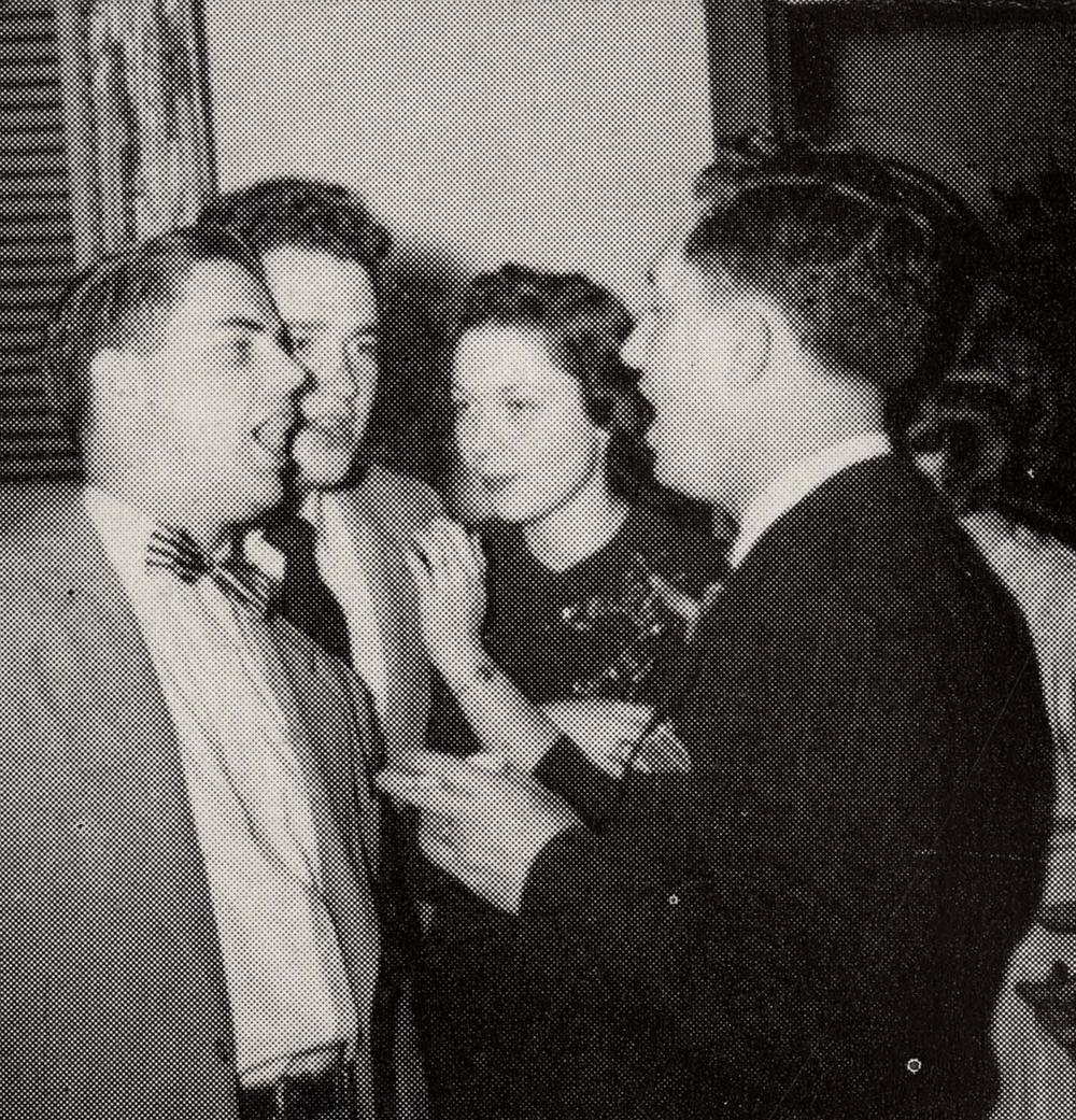 A group of well-dressed people talking and laughing.