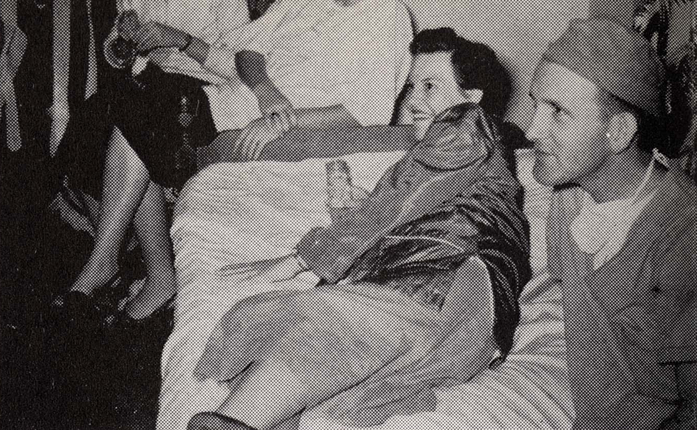 A few medical students lounge, one wearing surgical scrubs, another in a simple white dress.