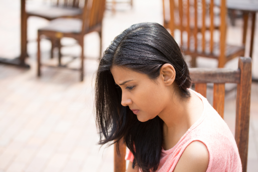 A woman with a despondent look on her face.