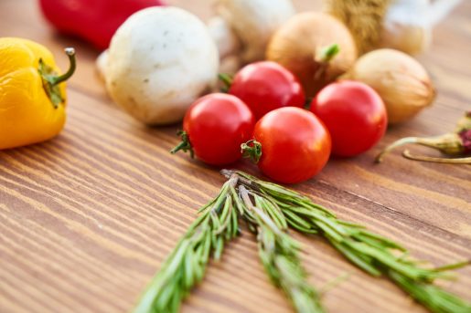 red-tomatoes-near-rosemary-and-other-spices-close-up-1435899