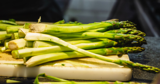 Raw asparagus on a cutting board.