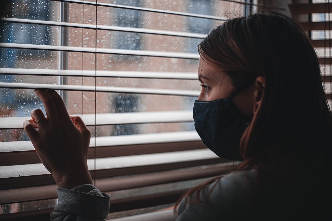 woman-with-mask-at-window