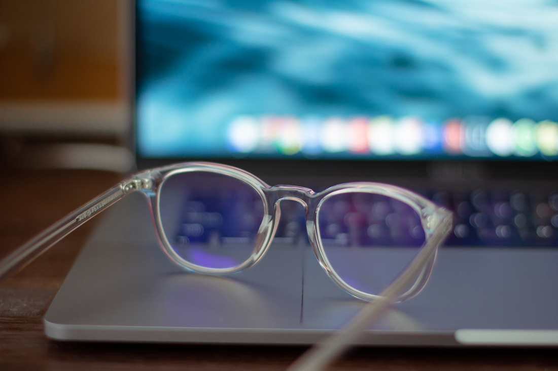 A Man Wearing Sunglasses while Typing on Laptop · Free Stock Photo