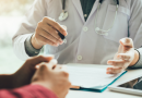 Doctor and Patient showing a patient information on a chart.