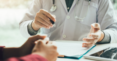 Doctor and Patient showing a patient information on a chart.