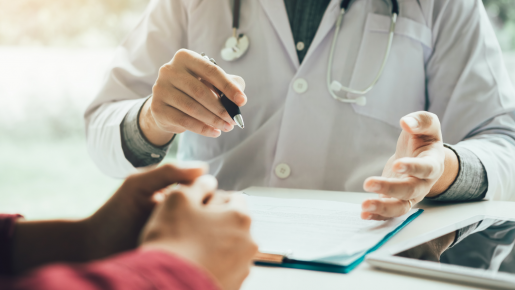 Doctor and Patient showing a patient information on a chart.