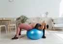 A person using a a yoga ball to exercise.