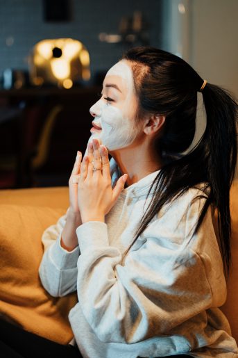 Woman putting on face mask.