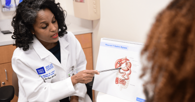 A bariatric surgeon uses a diagram of the human body to consult with a patient about the benefits of bariatric surgery.