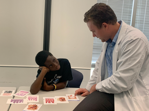 A Baylor student has a one-on-one mentoring session with a young man. 