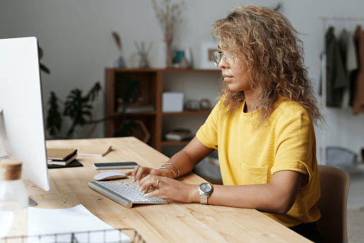 A person sitting comfortably at a computer while displaying proper posture