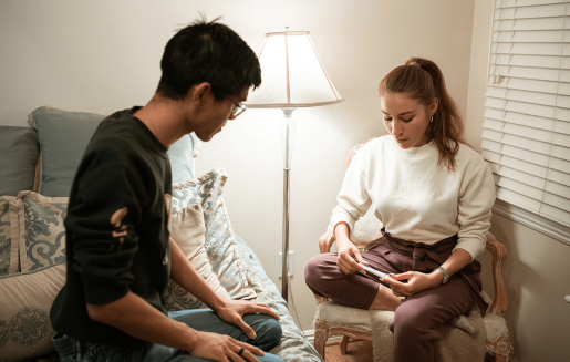 A mates  sits adjacent  to each   different   portion    looking down   to work   a gestation  test.