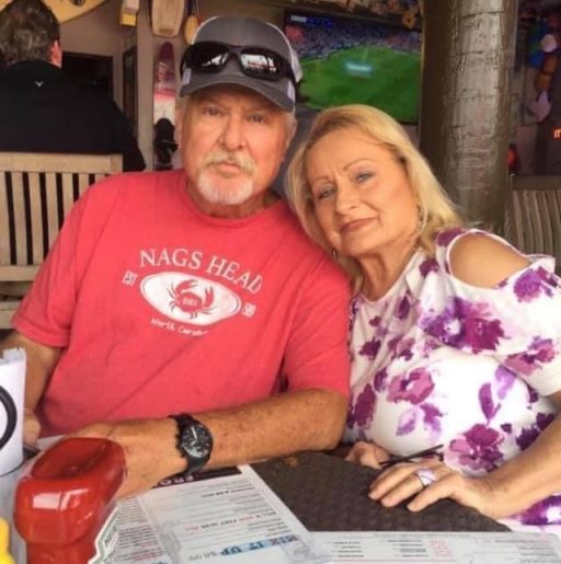 Daniel Kay and a companion sit on the porch of a restaurant. 