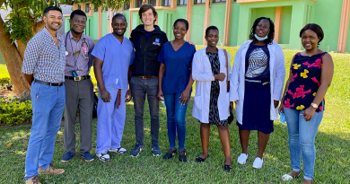 David Holmes stands outside with staff in Malawi at Kamuzu Central Hospital.