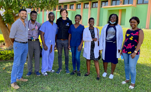 David Holmes stands outside with staff in Malawi at Kamuzu Central Hospital.