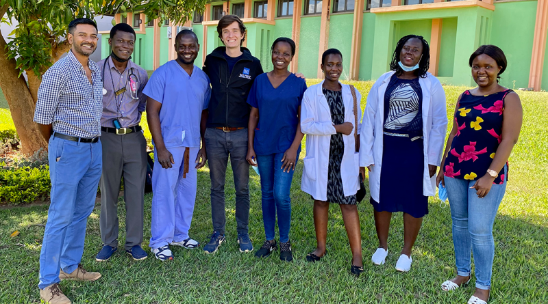 David Holmes stands outside with staff in Malawi at Kamuzu Central Hospital.