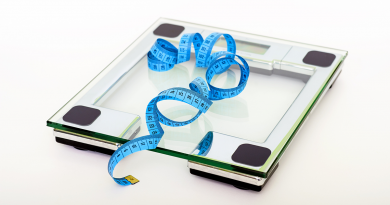 A measuring tape resting on an electric scale.