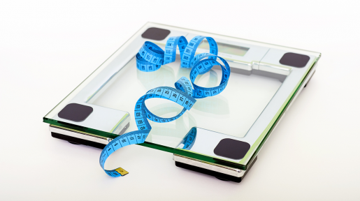 A measuring tape resting on an electric scale.