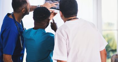 Three doctors examining medical imagery