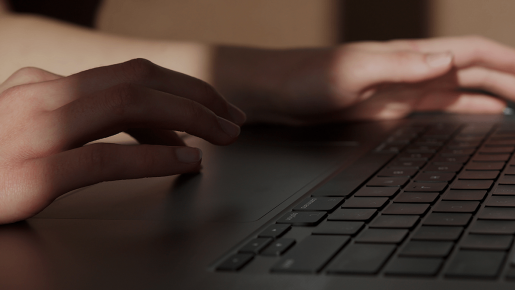 A pair of hands typing on a keyboard.