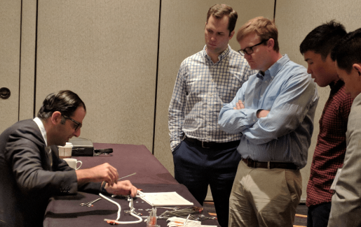 Dr. Ramyar Gilani showing a group of students physical models to represent Deep Vein Thrombosis