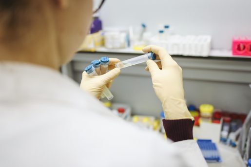 A doctor examining vials of liquids.