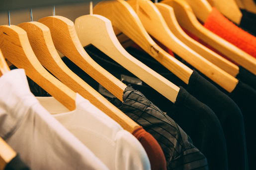 A selection of shirts and tops on hangers.