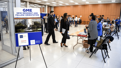 New trainees filter through tables at an orientation event