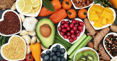 A spread of colorful fruits and vegetables, such as peppers, berries, avocado, nuts and kiwi.