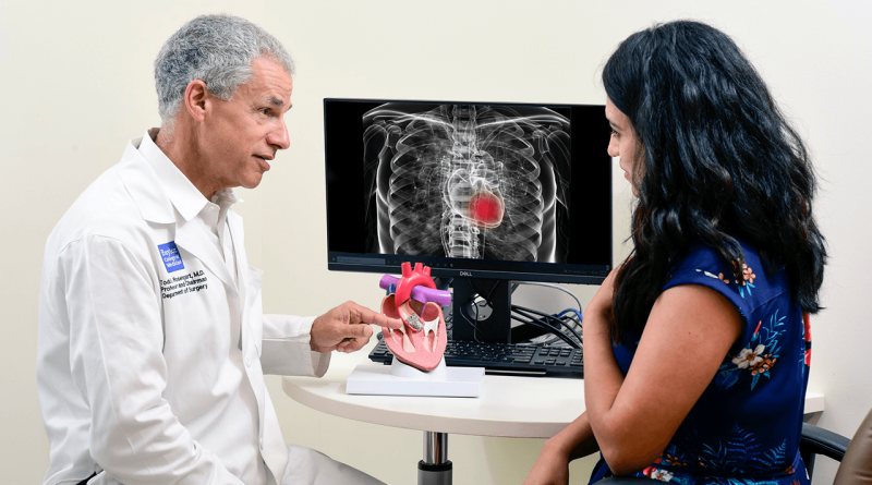 Dr. Todd Rosengart shows a patient a chest x-ray.