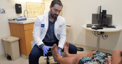 A doctor examining a patient's feet.