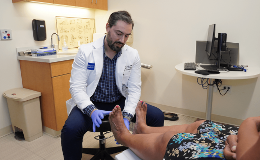 A doctor examining a patient's feet.