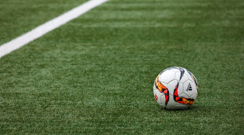 A soccer ball sitting on a field.