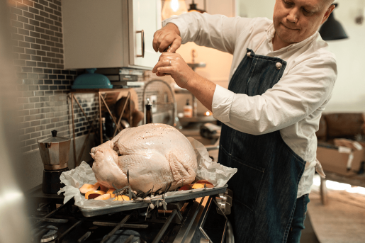 An uncooked turkey being prepared for roasting.