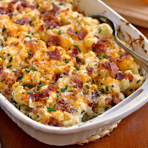 A casserole dish filled with cheesy baked cauliflower.