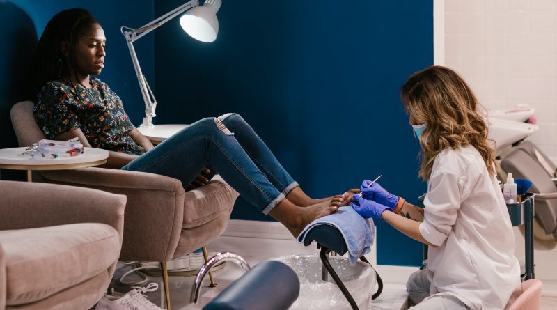 A technician works on a subject's feet during a pedicure.