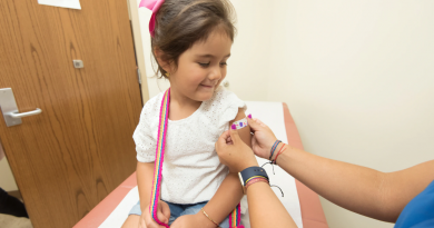 A child receiving a bandage after a vaccination