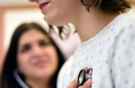 A doctor listening to a patient's heart