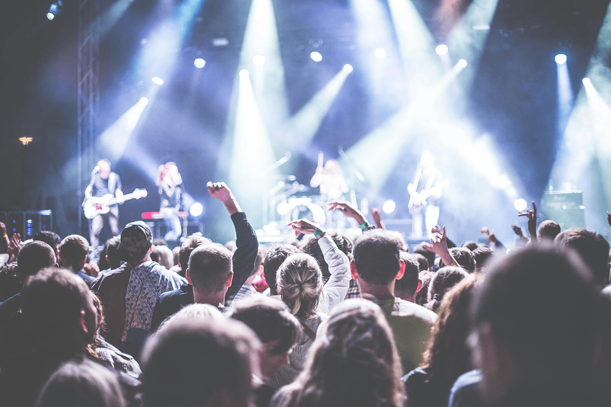 A crowd watching a band perform on stage.