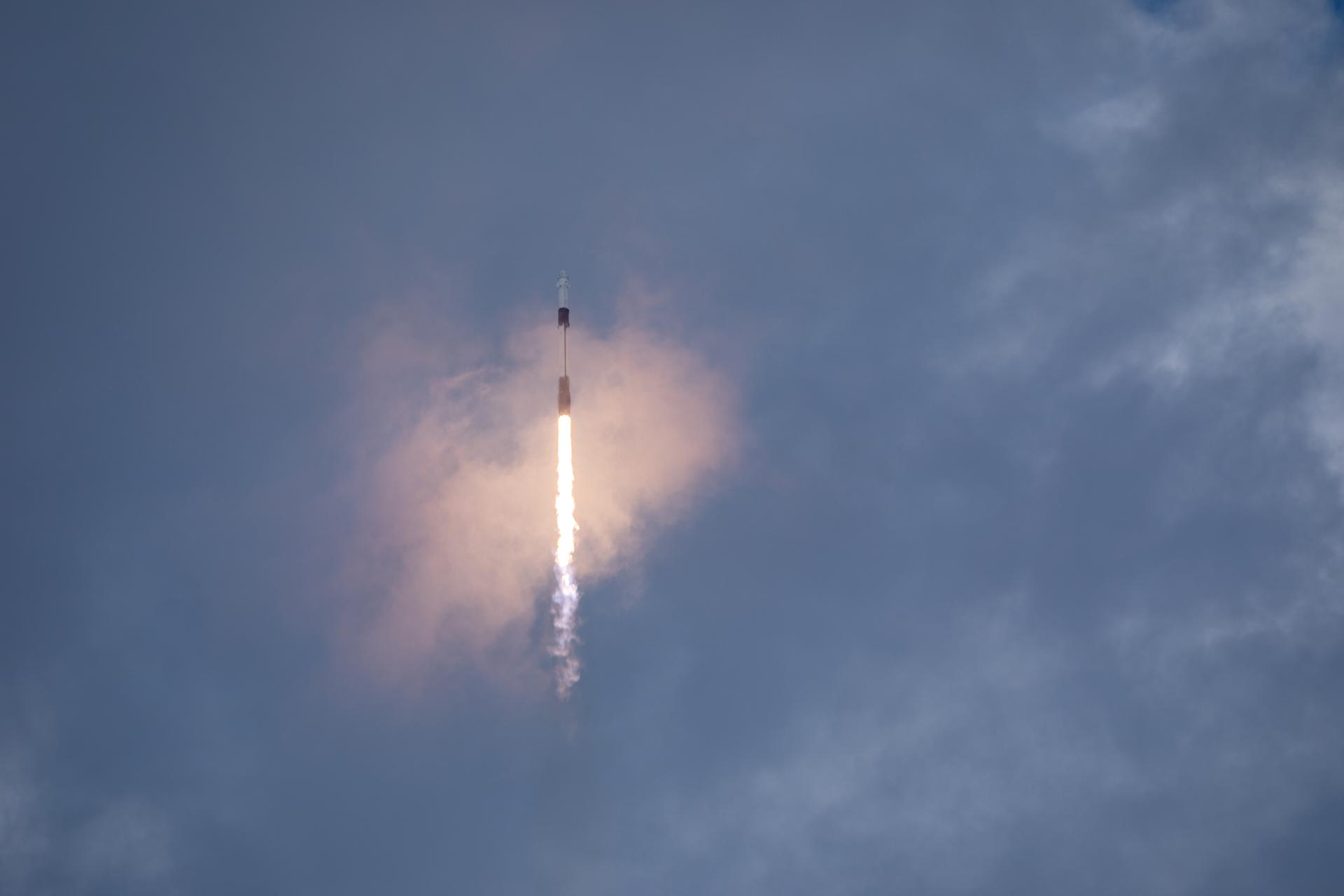 A SpaceX rocket carrying another spacecraft into orbit.