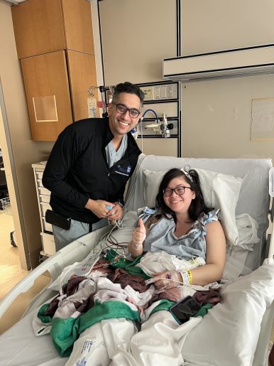 Patient Kailey Ratcliff in hospital bed with Dr. Omar Tanweer.