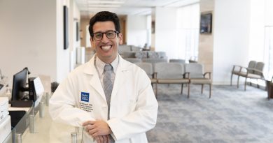 Dr. Jorge Miranda smiling brightly in a waiting room.