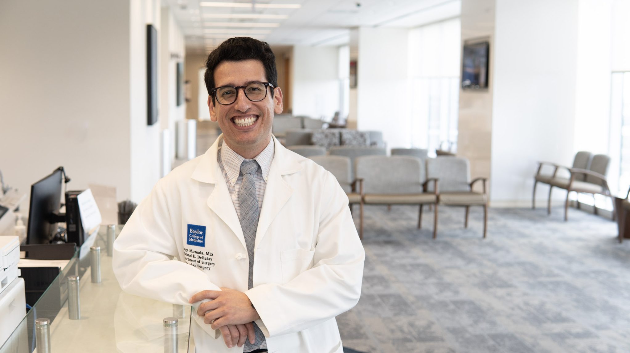 Dr. Jorge Miranda smiling brightly in a waiting room.