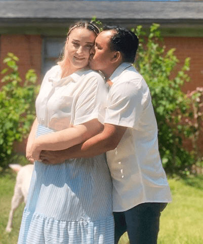 Karina Arango and her husband hugging outside